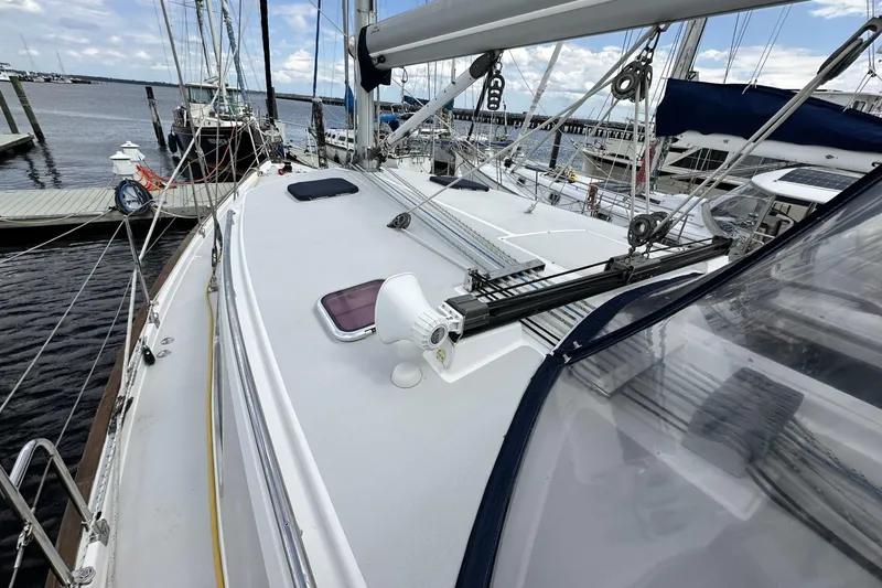 Slide: The Image of 2005 Catalina Morgan 440 sailboat docked at marina, showcasing deck and rigging. - 3