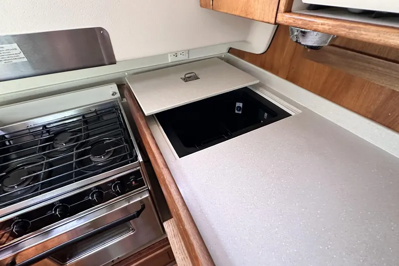 Slide: The Image of Galley kitchen in 2005 Catalina Morgan 440 yacht with stove and storage compartment. - 30