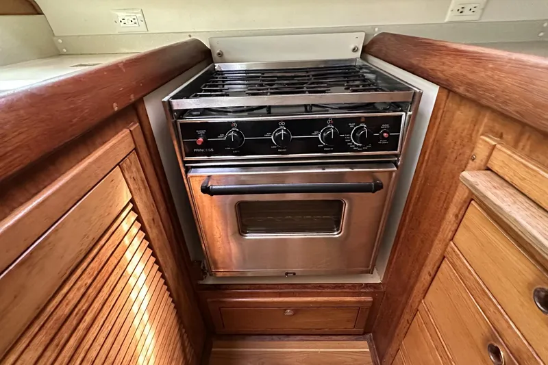 Slide: The Image of Stainless steel stove in 2005 Catalina Morgan 440 yacht kitchen, surrounded by wooden cabinetry. - 31