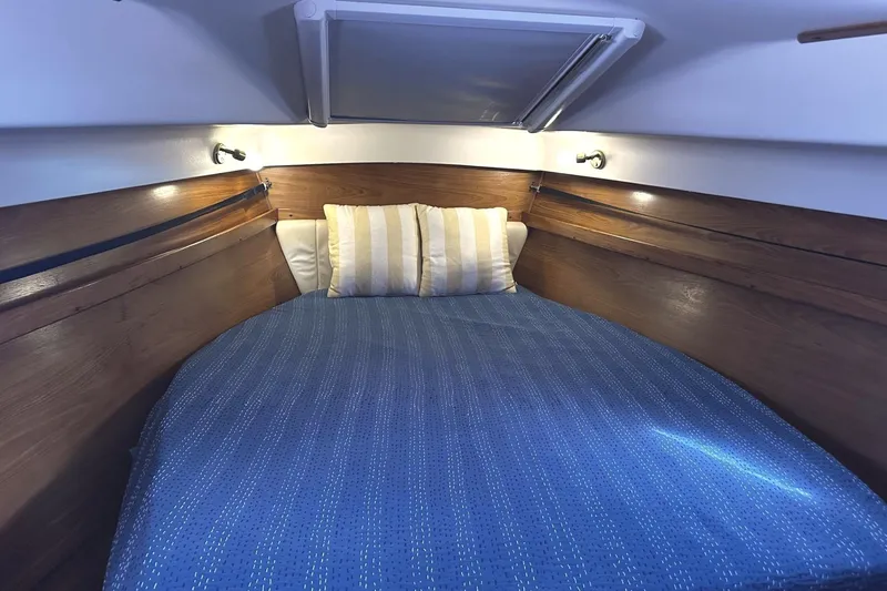 Slide: The Image of Interior of Catalina Morgan 440 yacht, cozy bed with blue cover. - 32