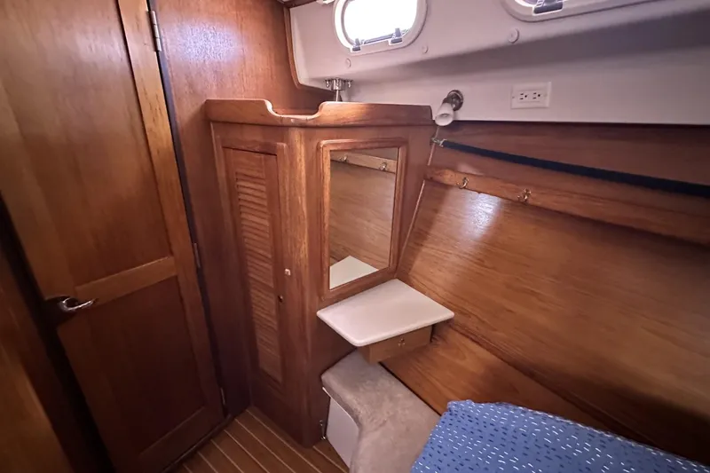 Slide: The Image of Cozy cabin interior of 2005 Catalina Morgan 440 sailboat with wooden furnishings. - 35