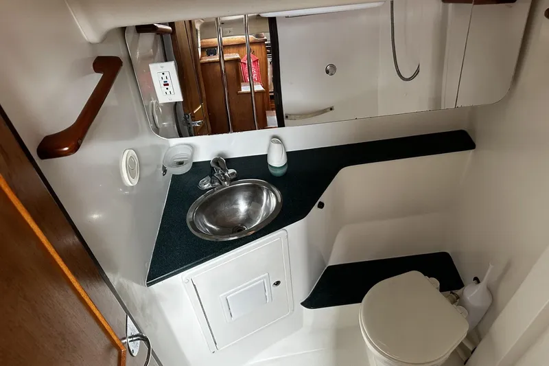 Slide: The Image of Compact bathroom in 2005 Catalina Morgan 440 yacht with sink, toilet, and mirror. - 40