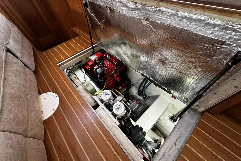 Slide: The Image of Engine compartment of 2005 Catalina Morgan 440 sailboat, featuring a well-maintained engine and components. - 42