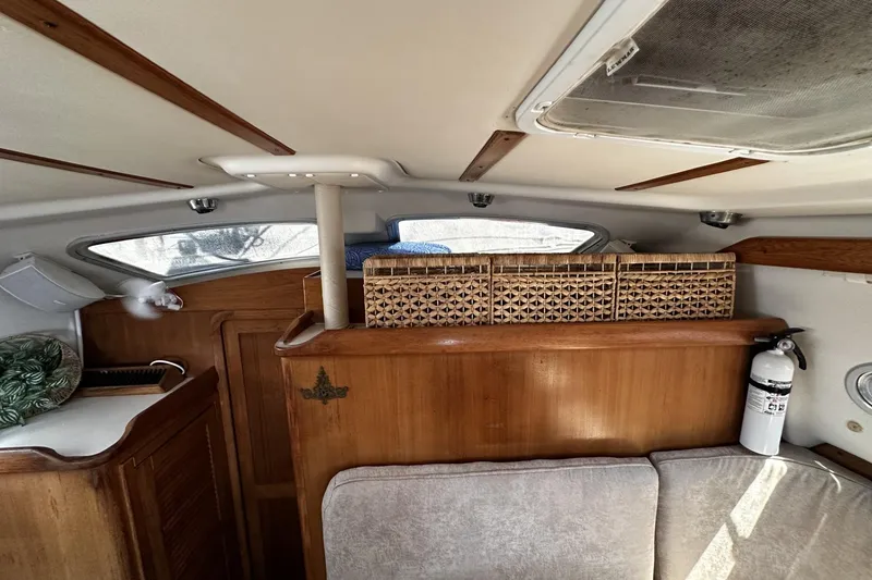 Slide: The Image of Interior of 2005 Catalina Morgan 440 sailboat with wooden cabinetry and wicker storage baskets. - 47
