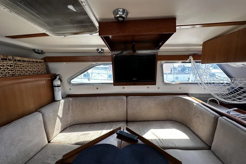 Slide: The Image of Interior of 2005 Catalina Morgan 440 yacht with cozy seating and mounted TV. - 48