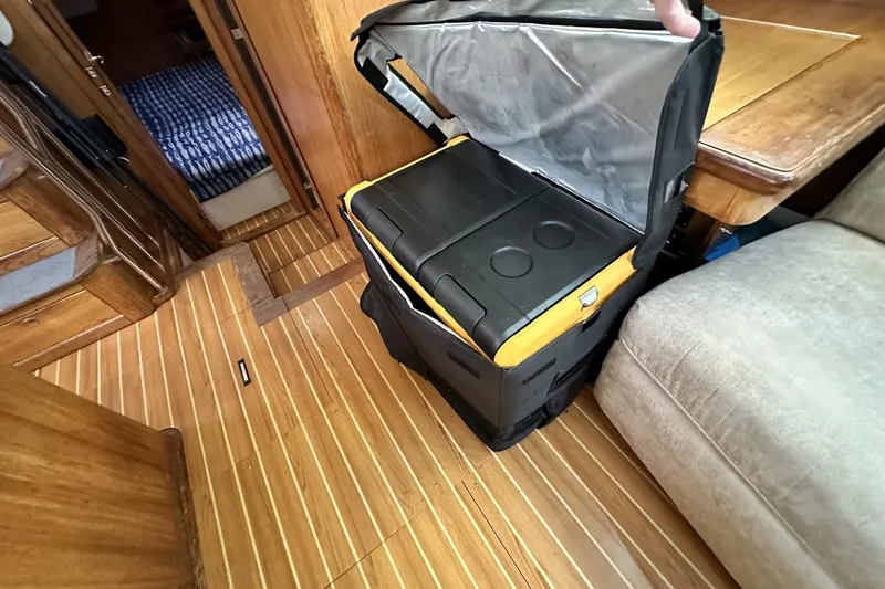 Slide: The Image of Interior of 2005 Catalina Morgan 440 yacht with portable cooler on wooden floor. - 51