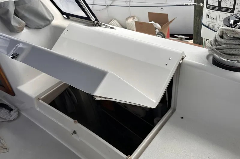 Slide: The Image of Open storage compartment on a 2005 Catalina Morgan 440 sailboat deck. - 54