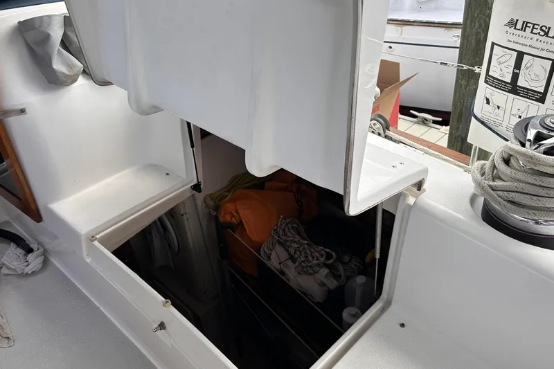 Slide: The Image of Open storage compartment on 2005 Catalina Morgan 440 sailboat deck with ropes and equipment. - 55