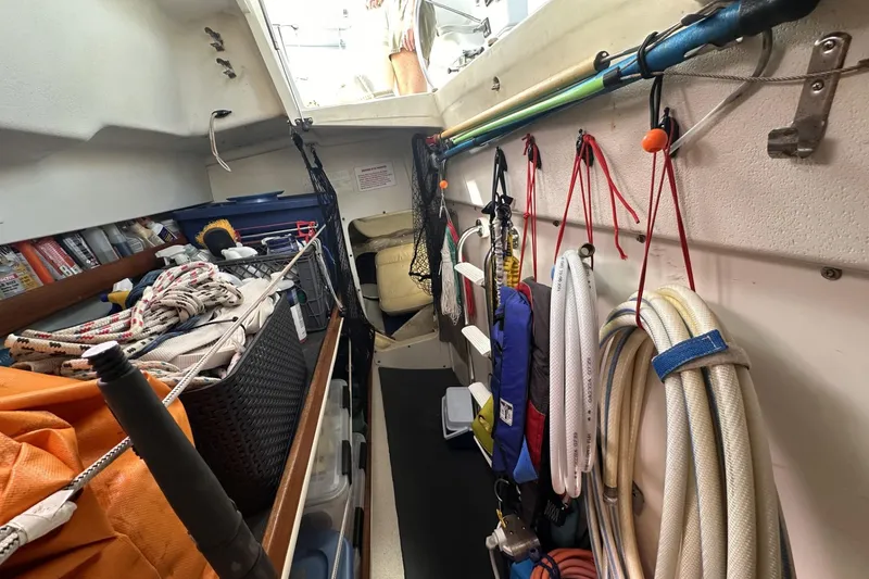Slide: The Image of Interior of a 2005 Catalina Morgan 440 sailboat with organized ropes and equipment. - 56