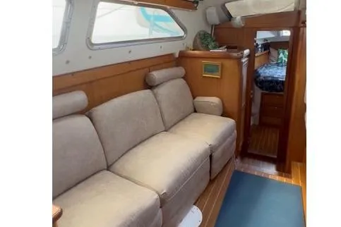 Slide: The Image of Interior of 2005 Catalina Morgan 440 yacht with beige sofa and wooden accents. - 6