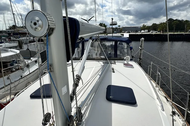 Slide: The Image of 2005 Catalina Morgan 440 sailboat docked at marina, showcasing deck and rigging. - 66