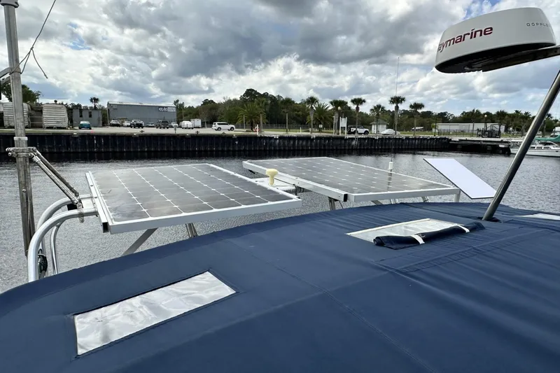 Slide: The Image of 2005 Catalina Morgan 440 sailboat with solar panels docked under cloudy skies. - 67