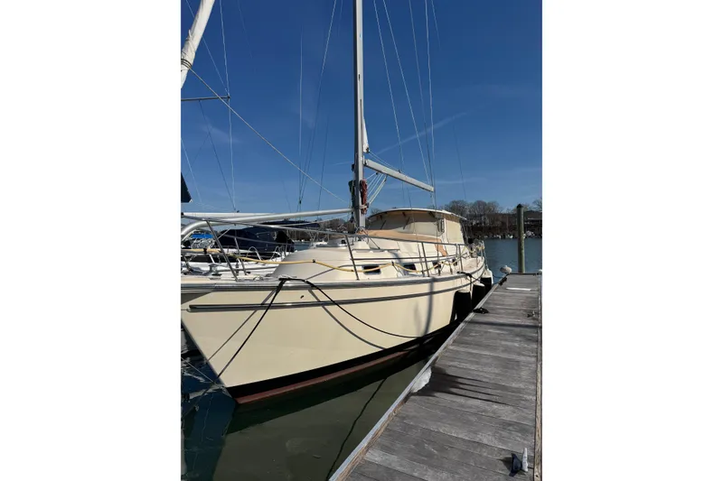 The Image of 2008 Island Packet SP Cruiser docked at marina under clear blue sky. - 0