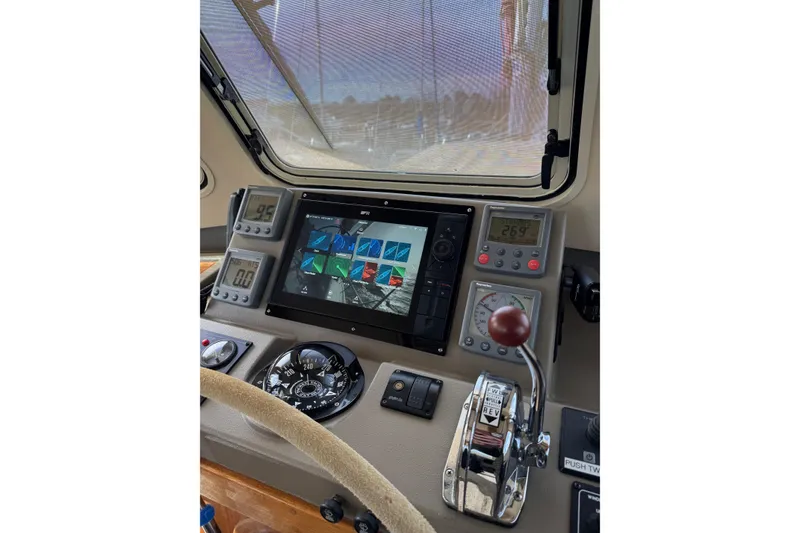Slide: The Image of 2008 Island Packet SP Cruiser helm with navigation instruments and controls. - 10