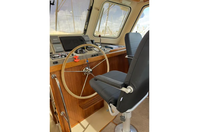 Slide: The Image of 2008 Island Packet SP Cruiser helm with steering wheel and captain's chair. - 11