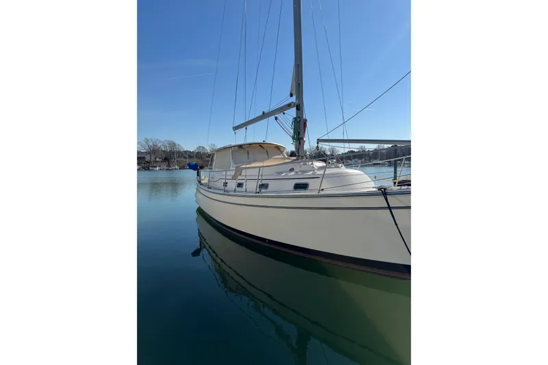 Slide: The Image of 2008 Island Packet SP Cruiser sailboat docked on calm water under clear blue sky. - 18