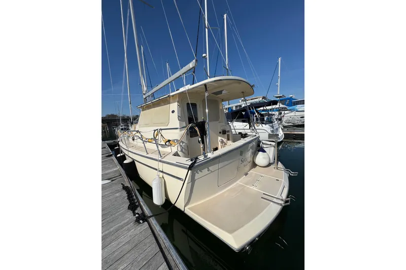 Slide: The Image of 2008 Island Packet SP Cruiser docked at marina, rear view. - 2