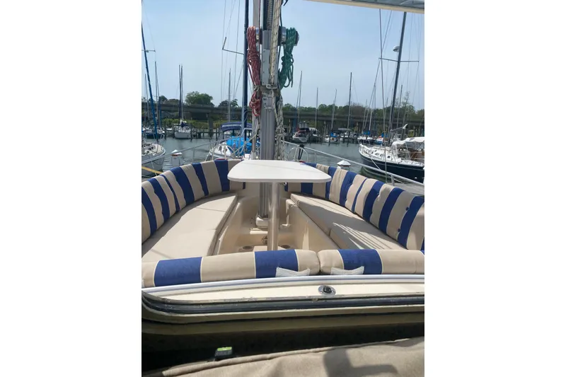 Slide: The Image of 2008 Island Packet SP Cruiser with striped seating in a marina setting. - 3