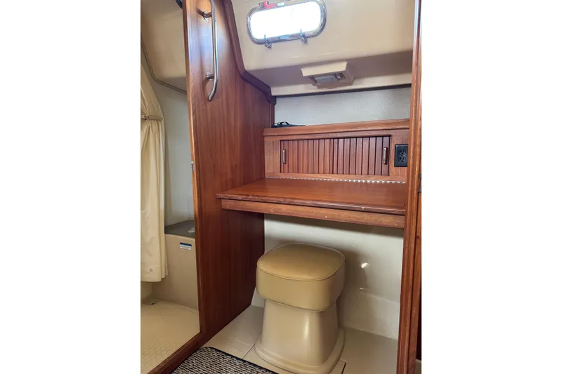 Slide: The Image of 2008 Island Packet SP Cruiser interior with wooden desk and beige seat. - 5