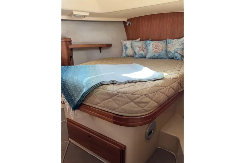 Slide: The Image of Cozy cabin interior of 2008 Island Packet SP Cruiser with nautical-themed pillows. - 7