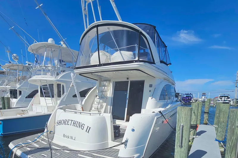 Slide: The Image of 2003 Meridian 411 Sedan yacht docked at marina under clear blue sky. - 1