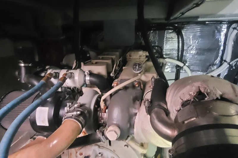 Slide: The Image of Engine compartment of a 2003 Meridian 411 Sedan with visible hoses and components. - 14