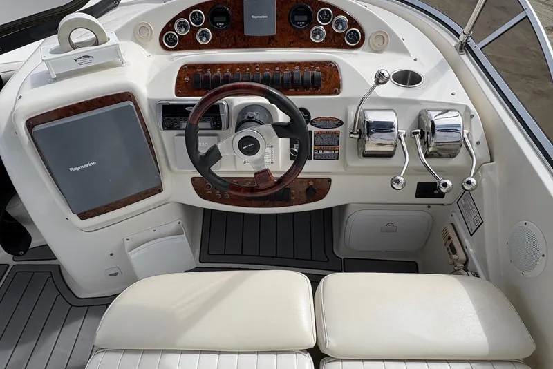 Slide: The Image of Cockpit of 2003 Meridian 411 Sedan with steering wheel, controls, and Raymarine equipment. - 19