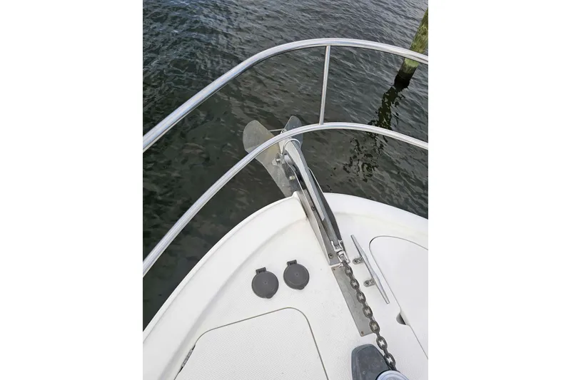 Slide: The Image of Bow of 2003 Meridian 411 Sedan yacht with anchor and railing over water. - 5
