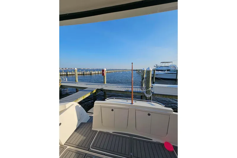Slide: The Image of 2003 Meridian 411 Sedan at marina with clear blue sky and calm waters. - 6