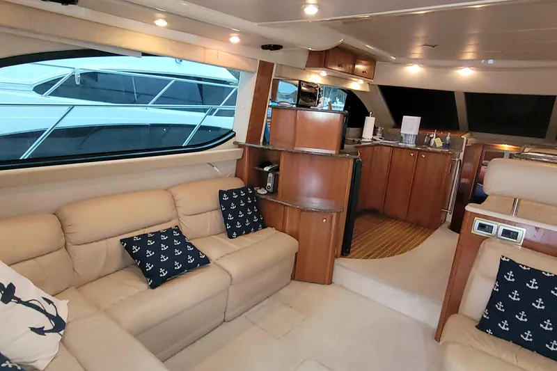 Slide: The Image of Luxurious interior of a 2003 Meridian 411 Sedan yacht with beige seating and nautical decor. - 7