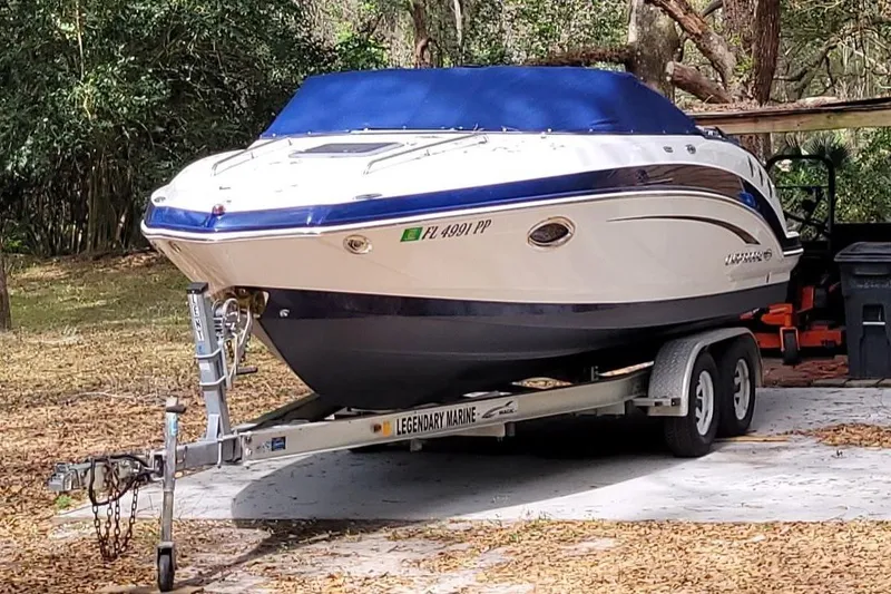 The Image of 2014 Chaparral 225 SSi boat on trailer, covered, parked outdoors. - 0