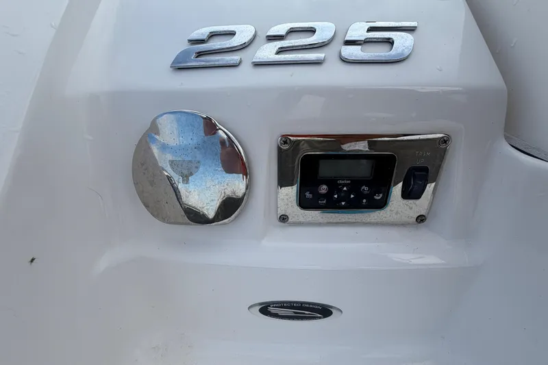 Slide: The Image of 2014 Chaparral 225 SSi boat dashboard with control panel and trim switch. - 12