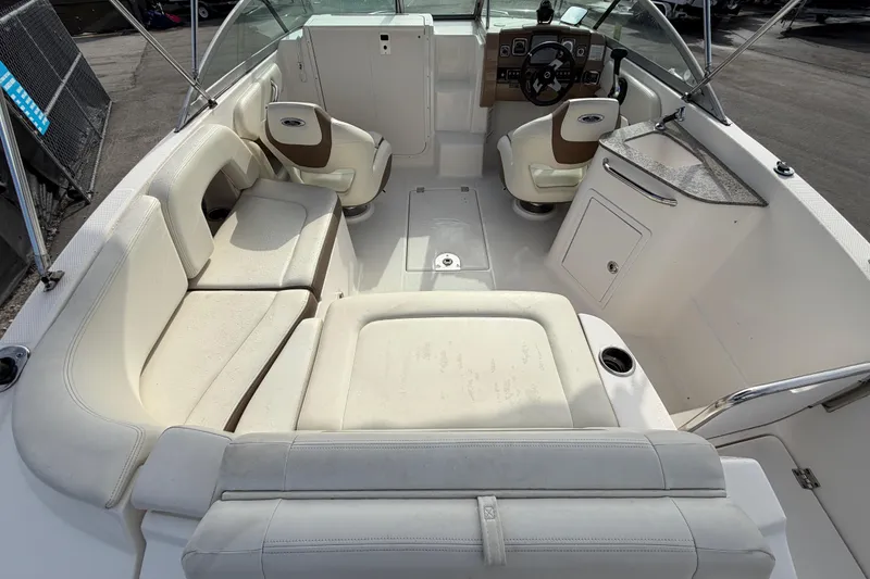 Slide: The Image of 2014 Chaparral 225 SSi boat interior with white seating and steering console. - 13