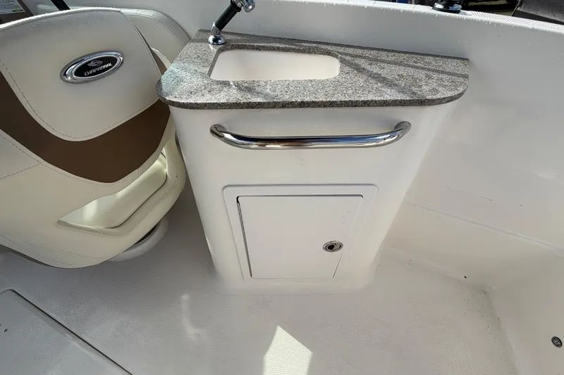 Slide: The Image of 2014 Chaparral 225 SSi boat interior with sink and storage compartment. - 17