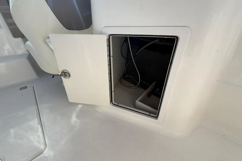 Slide: The Image of Open storage compartment on 2014 Chaparral 225 SSi boat interior. - 19