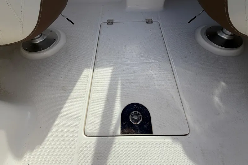 Slide: The Image of 2014 Chaparral 225 SSi boat interior with storage compartment and seating. - 21
