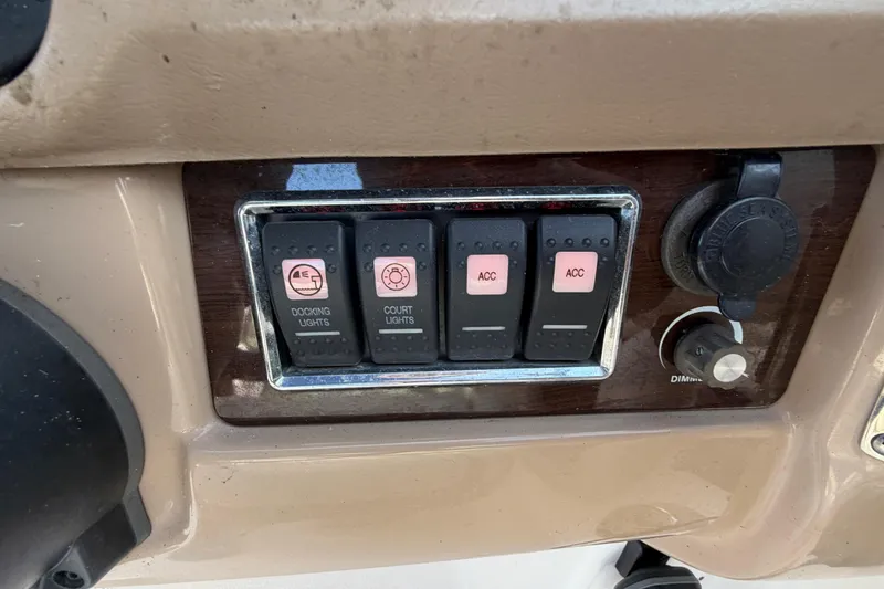 Slide: The Image of Control panel of a 2014 Chaparral 225 SSi boat with docking and court lights switches. - 25