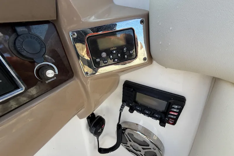 Slide: The Image of Control panel of 2014 Chaparral 225 SSi boat with radio and dimmer switch. - 27