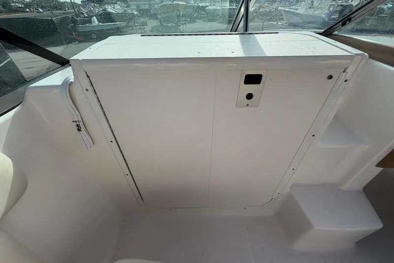 Slide: The Image of 2014 Chaparral 225 SSi boat interior with white panel and steps. - 30