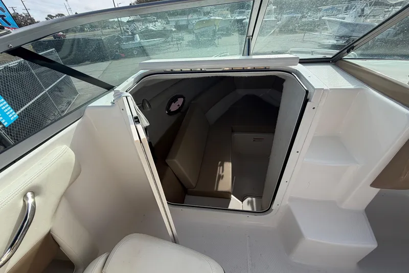 Slide: The Image of 2014 Chaparral 225 SSi boat cabin interior with open door and seating area. - 31