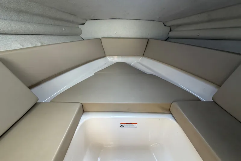 Slide: The Image of 2014 Chaparral 225 SSi boat interior with beige cushioned seating. - 33