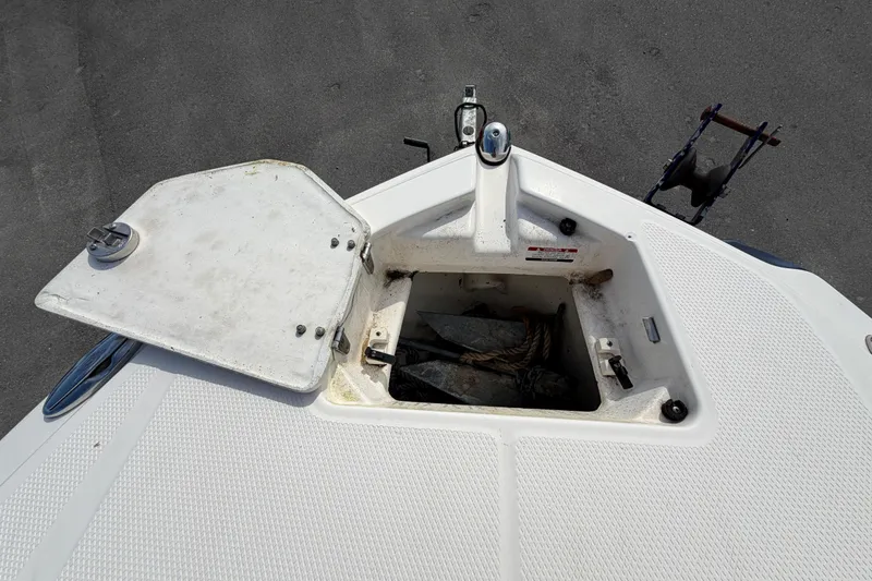 Slide: The Image of Open anchor compartment on 2014 Chaparral 225 SSi boat, showing storage area. - 38