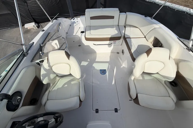 Slide: The Image of 2014 Chaparral 225 SSi boat interior with white seating and steering wheel. - 43