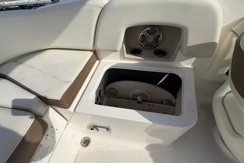 Slide: The Image of 2014 Chaparral 225 SSi boat interior with open storage compartment and speaker. - 47