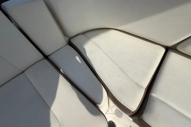 Slide: The Image of 2014 Chaparral 225 SSi boat interior seating with light upholstery. - 49