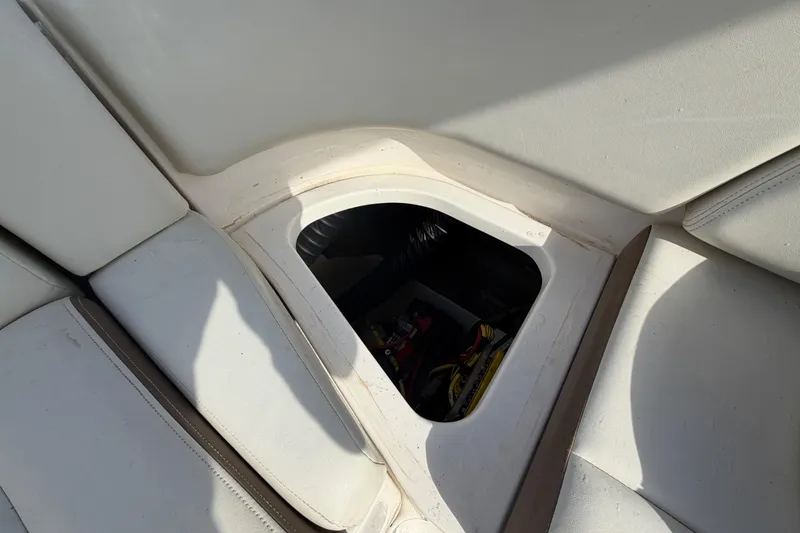Slide: The Image of 2014 Chaparral 225 SSi boat storage compartment with open hatch and visible interior. - 50