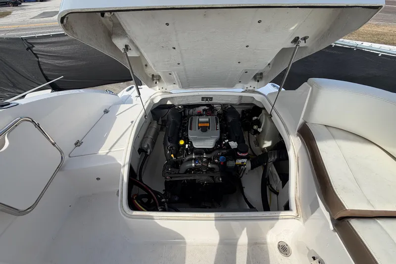 Slide: The Image of Open engine compartment of 2014 Chaparral 225 SSi boat, showcasing engine details. - 52