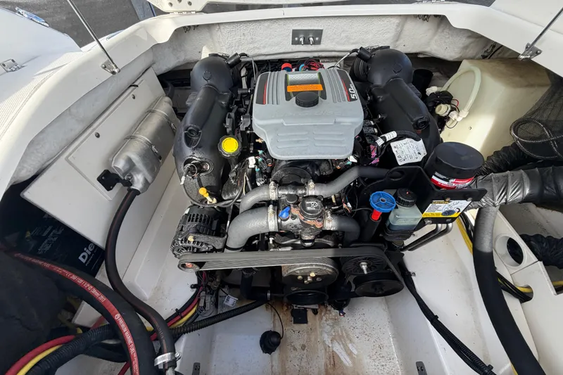 Slide: The Image of Engine compartment of a 2014 Chaparral 225 SSi boat, showcasing detailed components. - 53