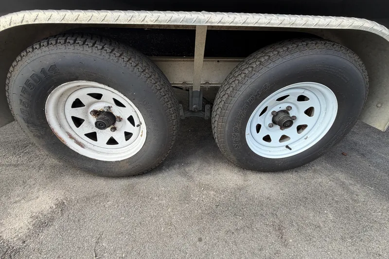 Slide: The Image of Trailer wheels for 2014 Chaparral 225 SSi boat on pavement. - 56