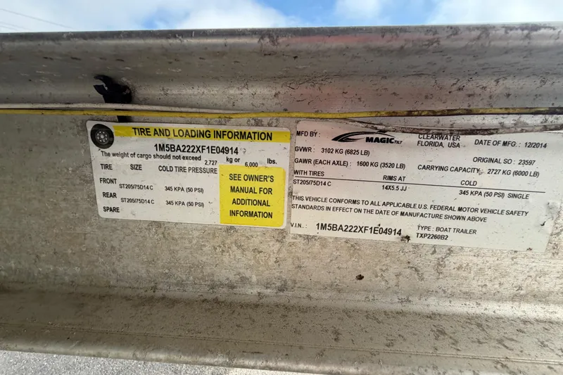 Slide: The Image of Tire and loading information label on a 2014 Chaparral 225 SSi boat trailer. - 57